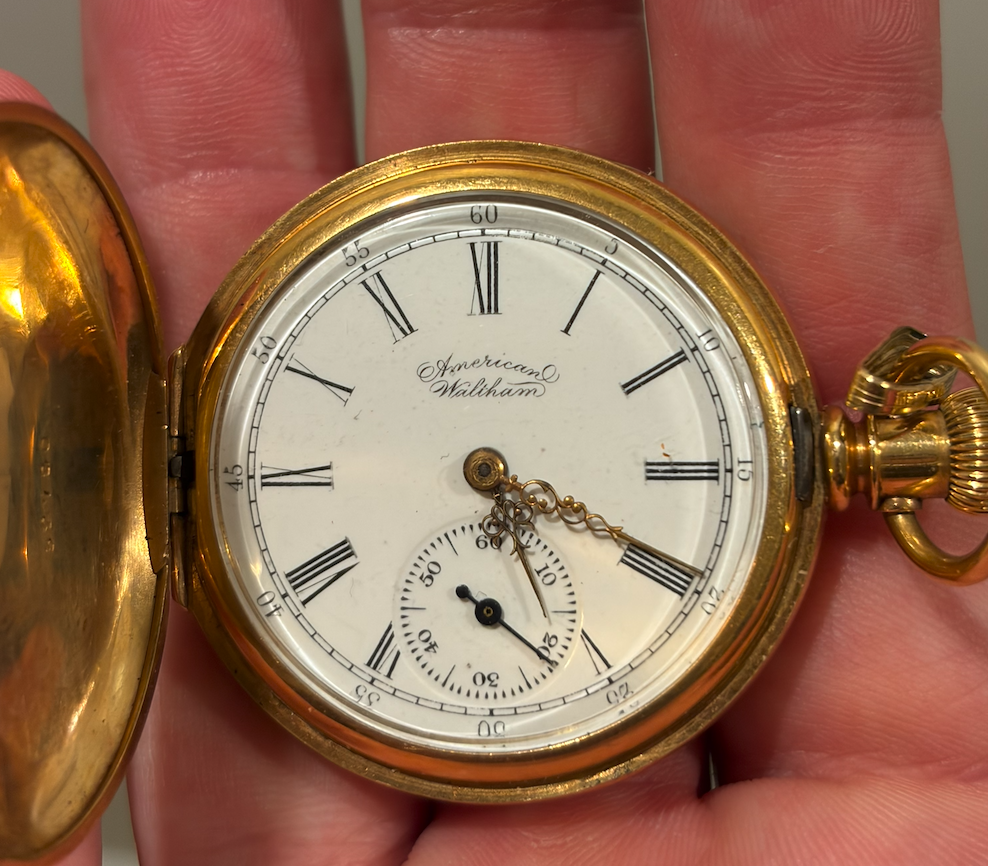 The family's American Waltham pocket watch, with Roman numerals and ornate hands.